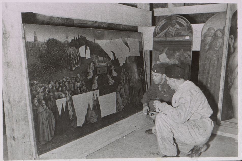 Angehörige der US-Streitkräfte bei der Begutachtung eines Altarteils des Genter Altars 1945, Wikimedia Commons, Gemeinfrei.