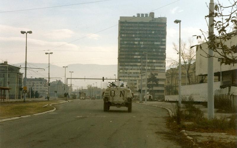 Norwegian Sisu from NORLOGBAT APC at "Sniper Alley" in Sarajevo, December 1995, Paalso, 1995, wikimedia Commons, Public Domain.