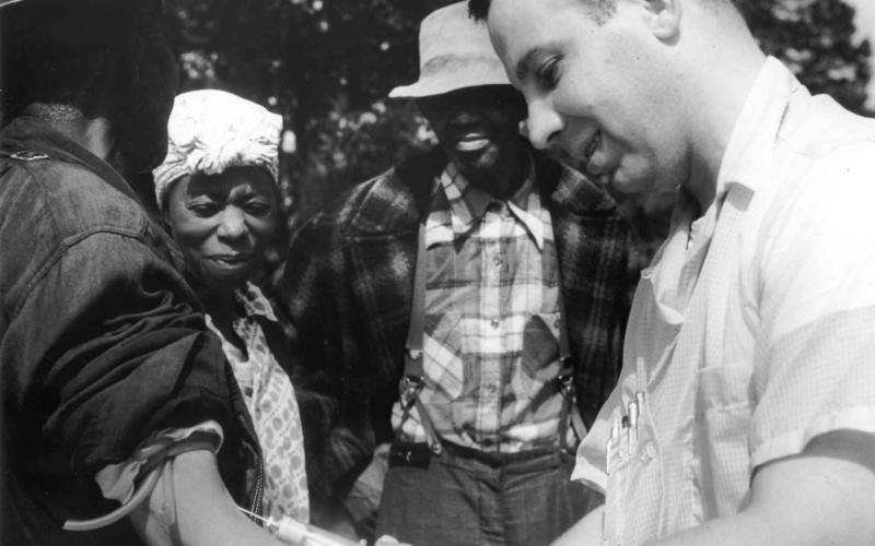 Doctor drawing blood from a patient as part of the Tuskegee Syphilis Study