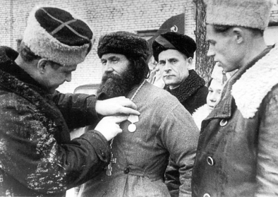 The village priest is awarded the medal The village priest is awarded the medal