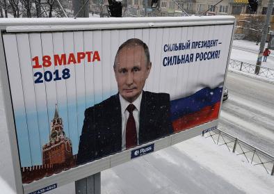 A pre-election banner with the image of the current president of the Russian Federation Vladimir Putin on one of streets of St. Petersburg A pre-election banner with the image of the current president of the Russian Federation Vladimir Putin on one of streets of St. Petersburg