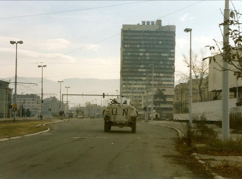 Norwegian Sisu from NORLOGBAT APC at "Sniper Alley" in Sarajevo, December 1995, Paalso, 1995, wikimedia Commons, Public Domain.