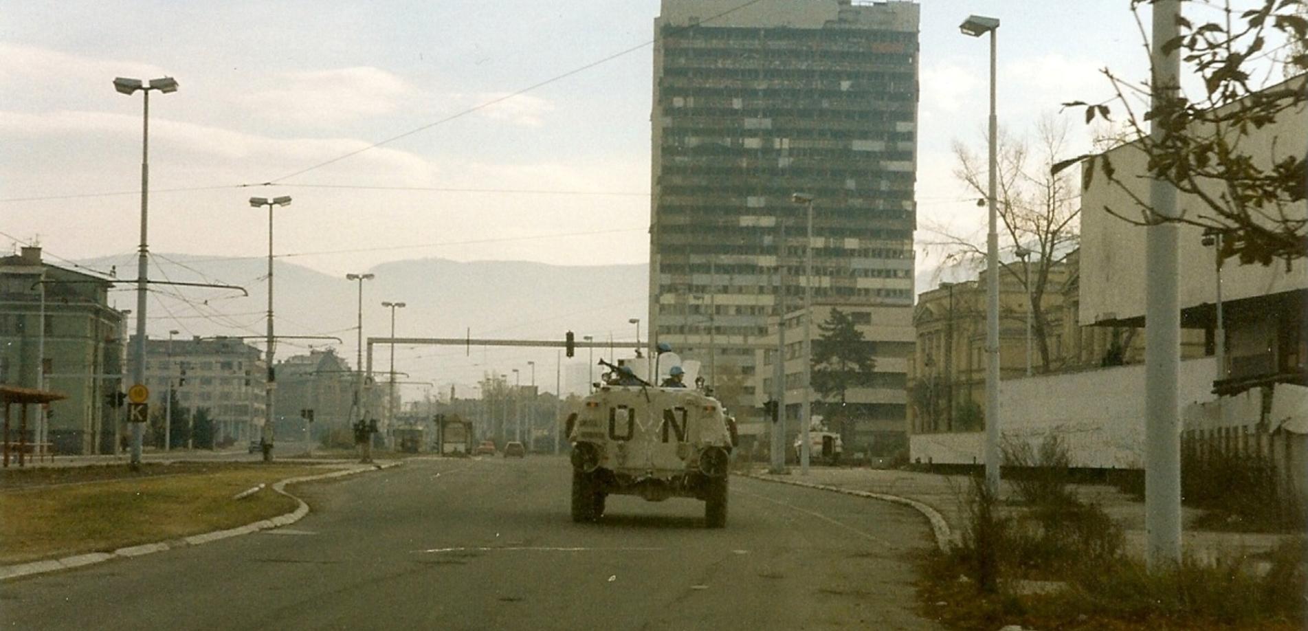 Norwegian Sisu from NORLOGBAT APC at "Sniper Alley" in Sarajevo, December 1995, Paalso, 1995, wikimedia Commons, Public Domain.