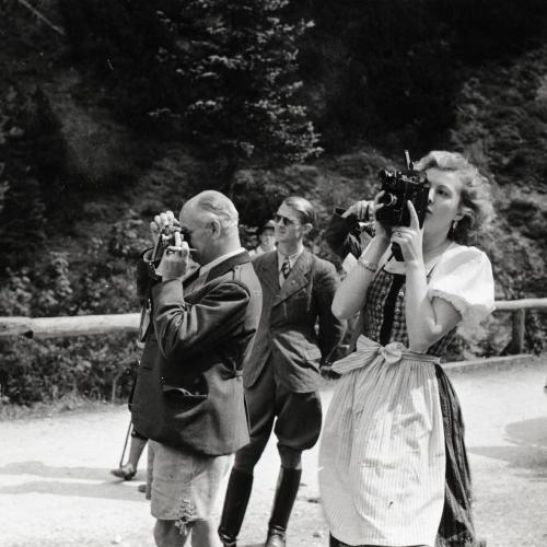 Eva Braun fotografiert, im Hintergrund Nazimänner, die ebenfalls fotografieren