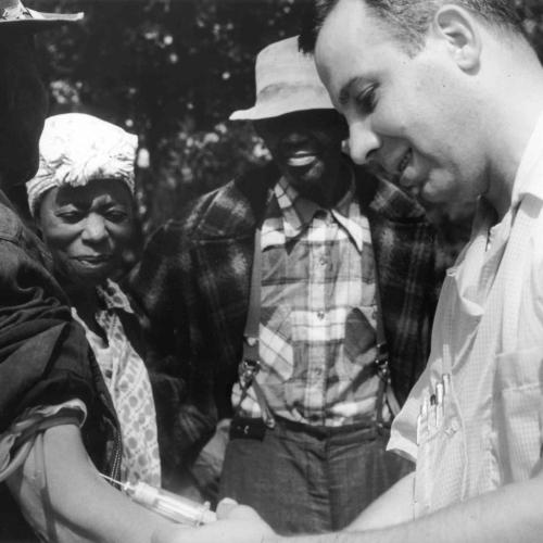 Doctor drawing blood from a patient as part of the Tuskegee Syphilis Study