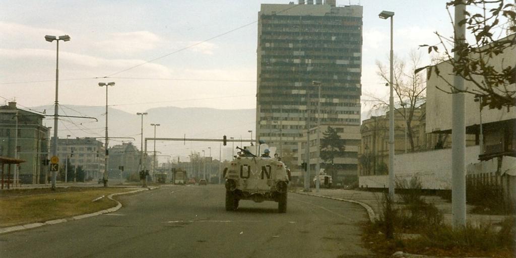Norwegian Sisu from NORLOGBAT APC at "Sniper Alley" in Sarajevo, December 1995, Paalso, 1995, wikimedia Commons, Public Domain.