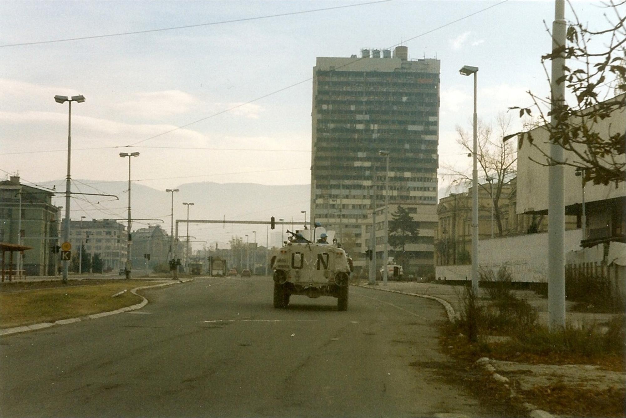 Norwegian Sisu from NORLOGBAT APC at "Sniper Alley" in Sarajevo, December 1995, Paalso, 1995, wikimedia Commons, Public Domain.
