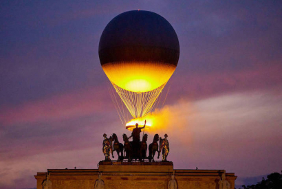 The Cauldron With The Olympic Flame Lit Flies Seen From The Louvre